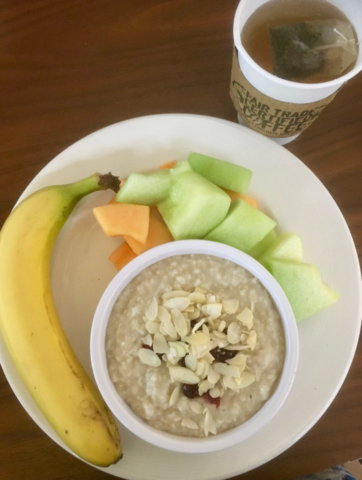 Hotel Vegan Breakfast Spread - oatmeal with nuts and dried fruit, fresh fruit and green tea