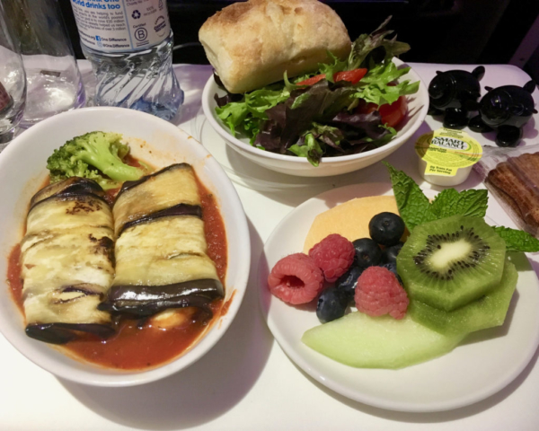 Airplane vegan dinner - stuffed baked courgette, salad, fresh fruit salad