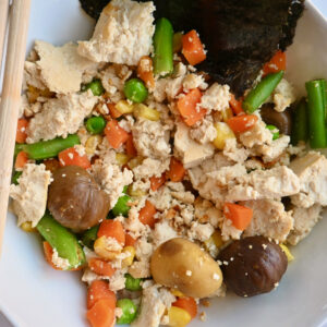 A bowl of stir-fry tofu with chestnuts and veggies